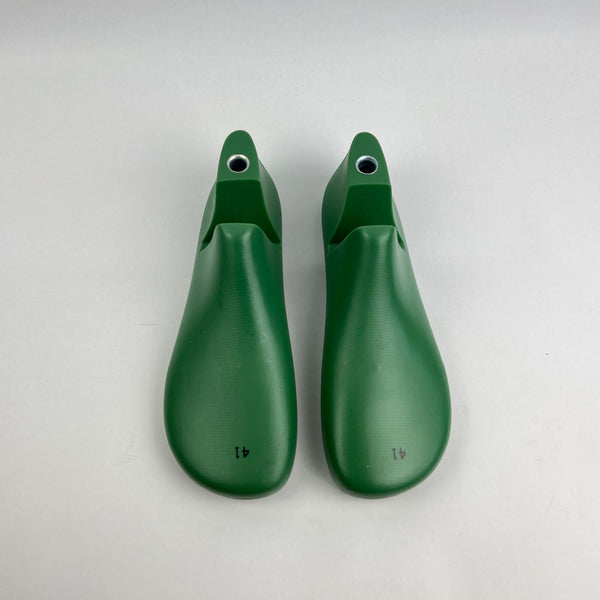 Pair of green barefoot shoe last on a white background