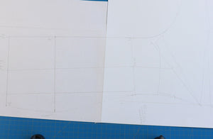 Drawing the high knee boot pattern manually on paper during the VALEVRO online shoemaking and patternmaking course.