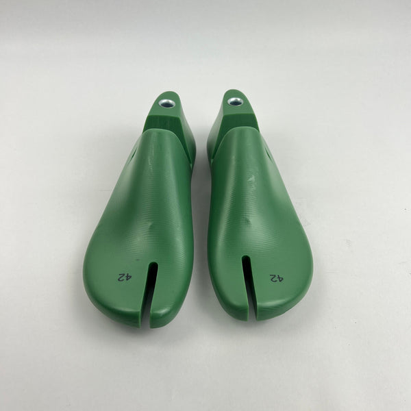 Pair of green shoe last on a white background