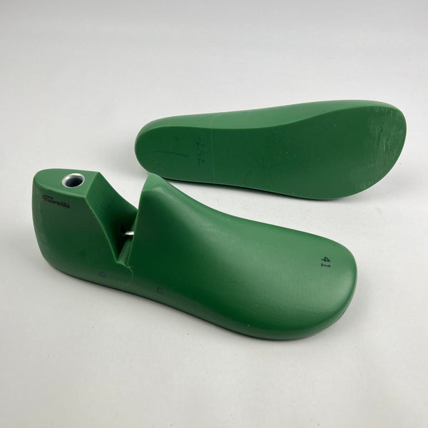 Pair of green barefoot shoe last on a white background
