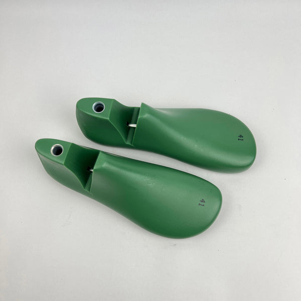 Pair of green barefoot shoe last on a white background