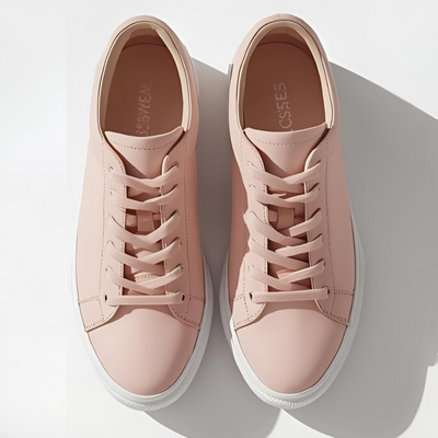 A pair of light pink leather sneakers, with a clean gray background, made by a VALEVRO student.